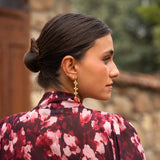 Gold flower chain and stone earrings | Tile